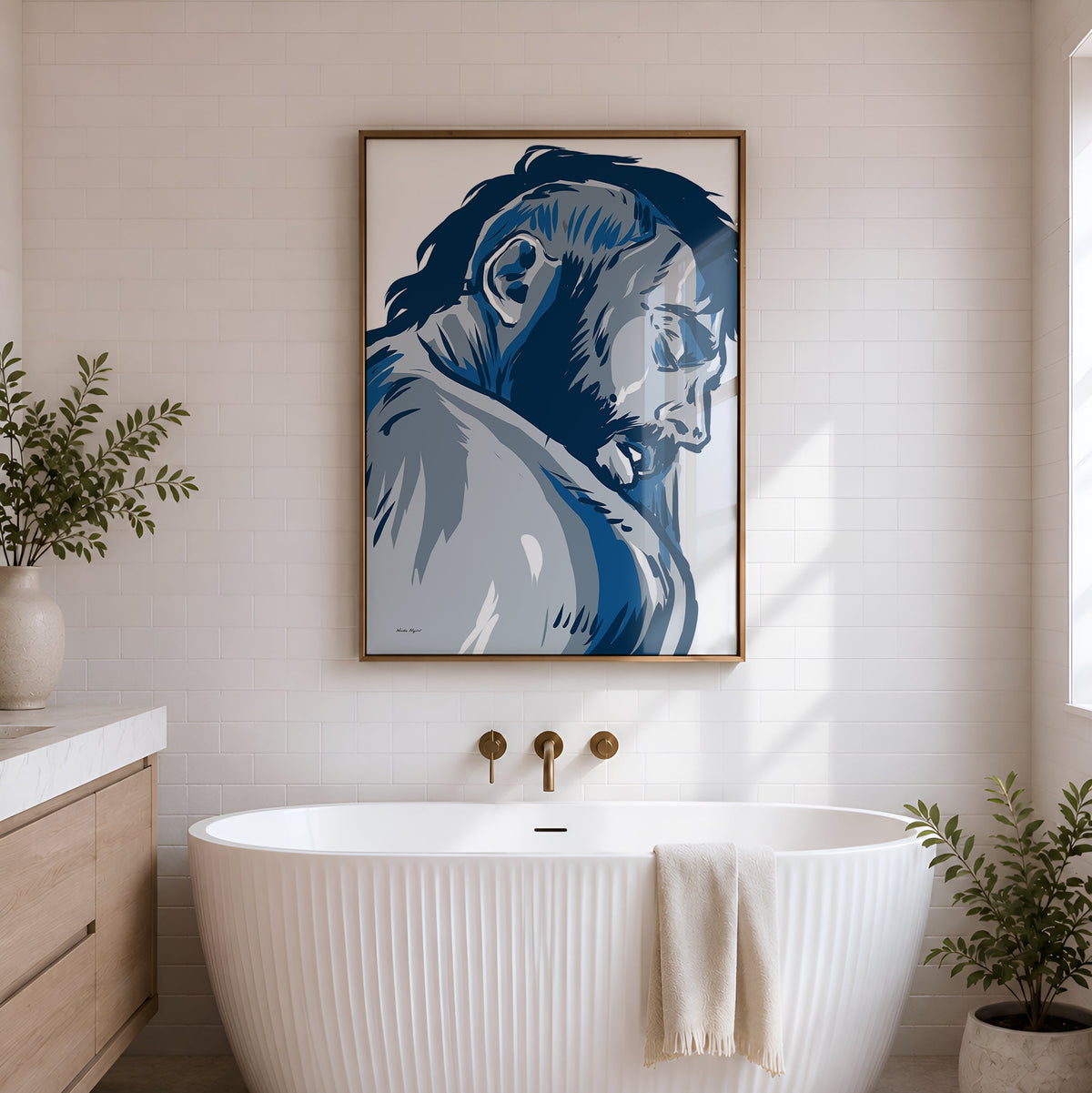 A modern freestanding bathtub in a bright bathroom, with a large framed blue-toned portrait artwork hanging above it on a white shiplap wall.