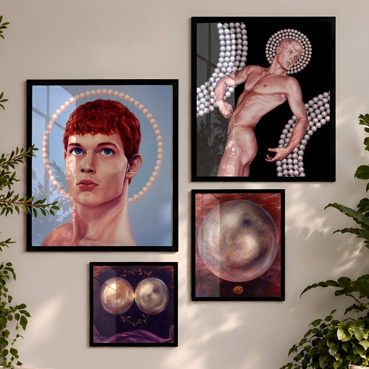 A styled living room with four framed art prints displayed on a light beige wall above a wooden coffee table and sofas. The prints feature surreal portraits and abstract figures, surrounded by lush green plants.