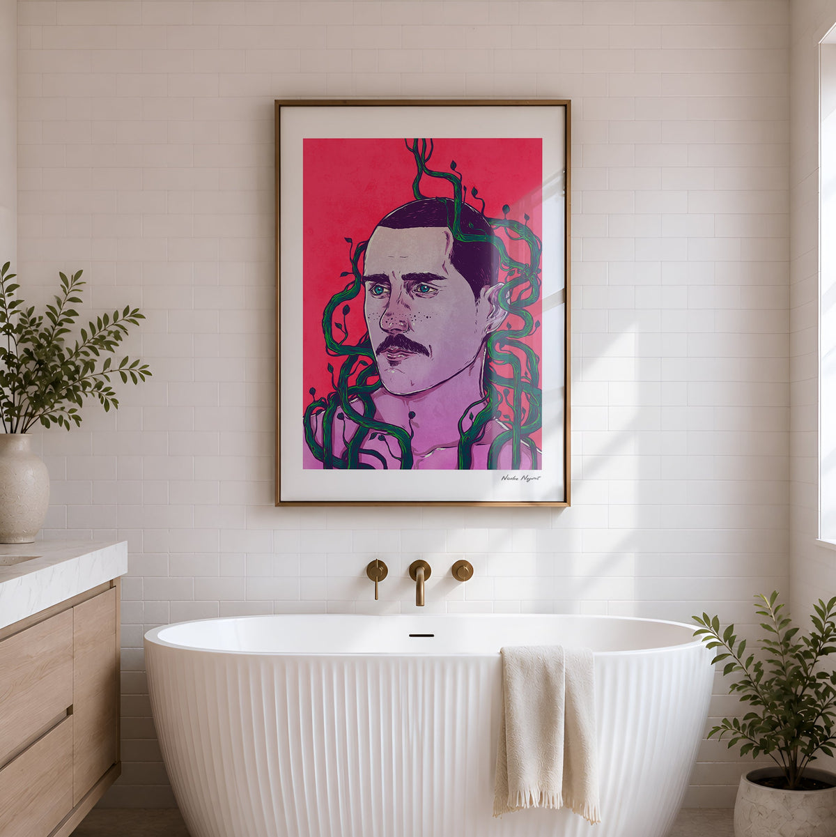 A framed pop-art portrait print hangs on a white shiplap wall above a freestanding white tub in a bright bathroom. The artwork features a stylized face with dark green snakes on a vivid pink background.