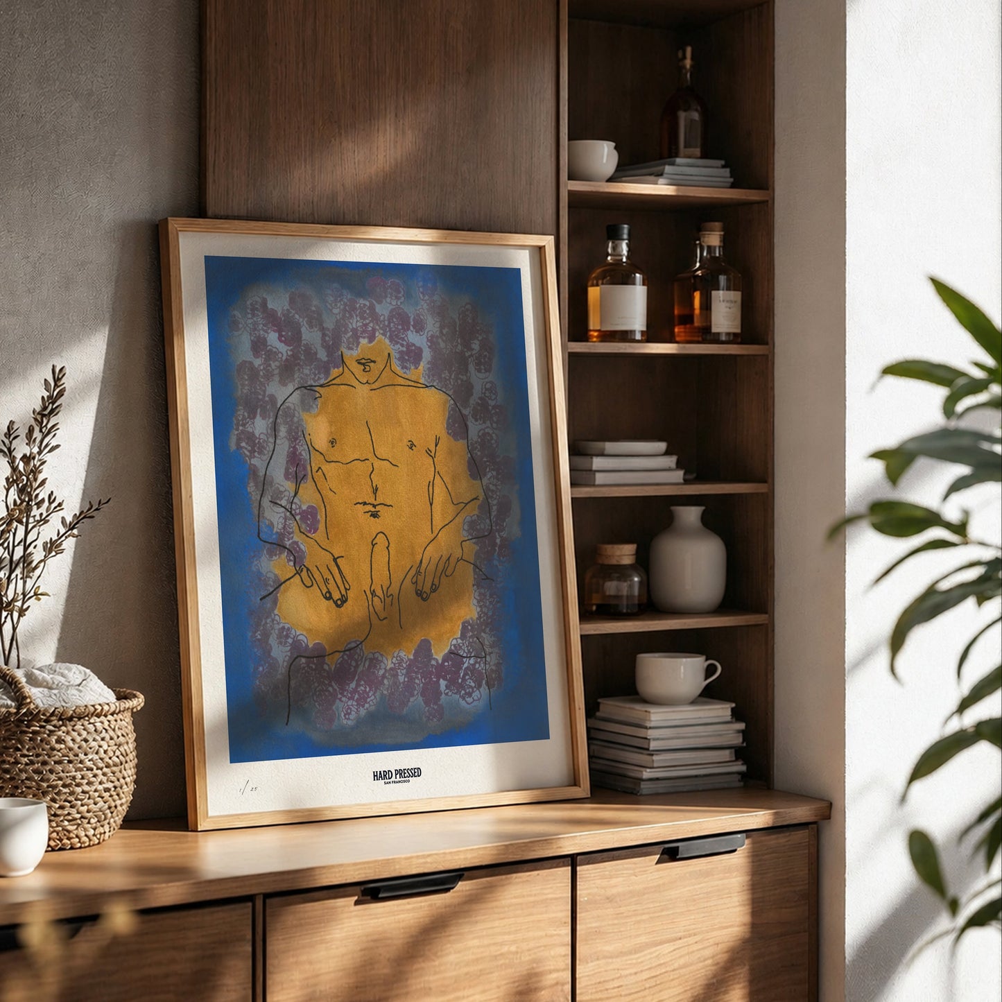 Framed artwork on a wooden shelf with decorative items