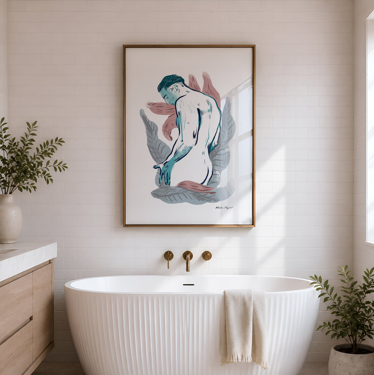 A framed art print depicting a stylized nude female figure in blue, pink, and gray tones with a gold frame, hanging on a white brick wall above a white freestanding bathtub in a bright bathroom.