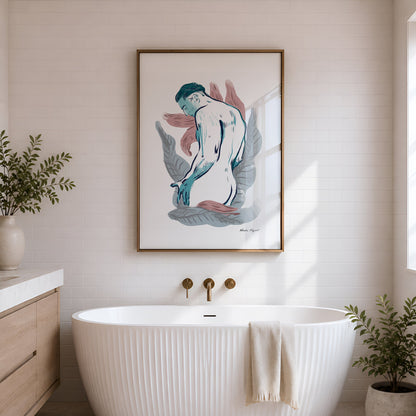 A framed art print depicting a stylized nude female figure in blue, pink, and gray tones with a gold frame, hanging on a white brick wall above a white freestanding bathtub in a bright bathroom.