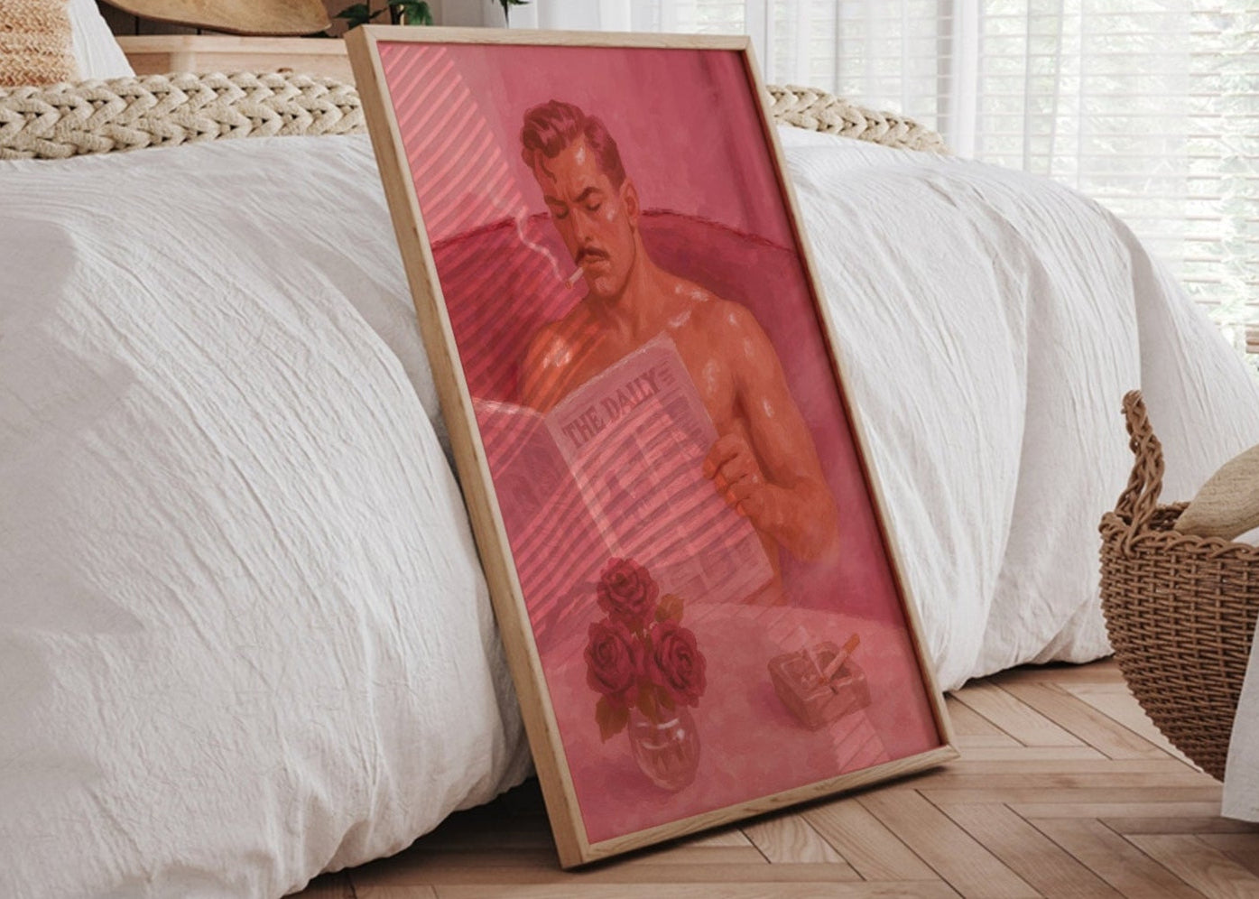 Framed artwork leaning against a bed in a bedroom with natural light